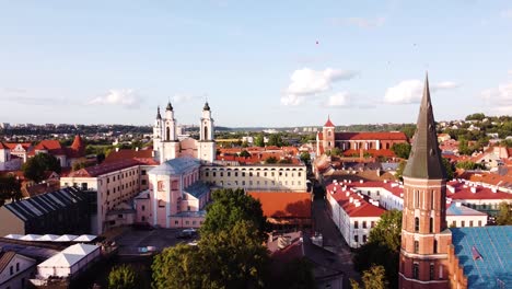 Kaunas-city-old-town-aerial-drone-shot-while-the-drone-is-flying-backwards-revealings-beautiful-church-towers
