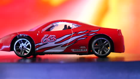 Red-toy-car,-colorful-miniature-sport-cars,-muscle-car-illustration,-transportation,-automobile-layout,-race-cars-model-rotating,-3d-studio-background