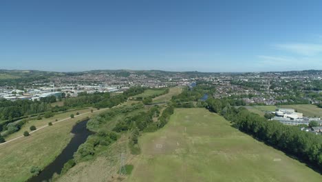 Approaching-Exeter-City-in-Devon,-by-air,-along-the-River-Exe,-on-a-sunny-day