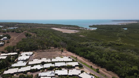 Bird-Flying-in-front-of-Aerial-Drone-shot-of-Fannie-Bay-in-Darwin,-Northern-Territory