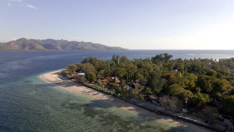 Aerial-view-showing-beach-and-ocean-shore-of-Gili-Air-Island-and-Lombok-Island-in-background