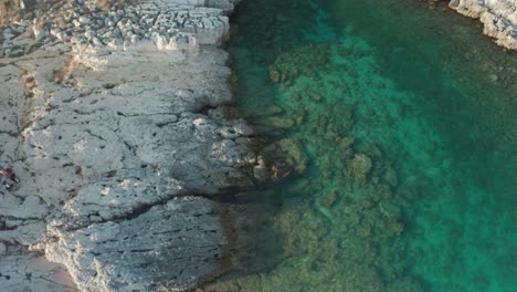 Drone-shot-of-a-small-lagoon,-camera-turns-to-the-right