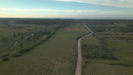 Dirt-road-winding-through-farmlands-in-Polish-plain
