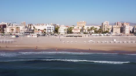 Sideways-aerial-view-of-the-Muchavista-Beach-early-in-the-morning-on-a-nice-and-sunny-autumn-day