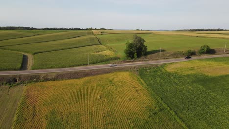 Cars-passing-by-on-a-freeway-on-the-country-side-in-south-Minnesota-aerial-view
