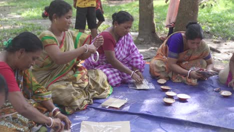 Asian-tribal-women-working-together-handcraft-items-at-outdoor,-feminism-and-self-independent-married-women,-slow-pan-shot-to-right