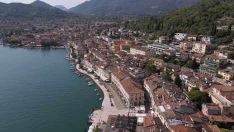 Aerial-view-of-idyllic-sunny-Garda-lake-and-Salo-city-promenade,-Lombardy,-Italy-on-summer-day