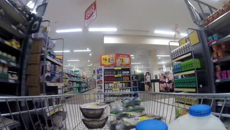 Timelapse-Inside-supermarket-shopping-cart-pushing-trolley-down-aisle-as-customers-shop-during-corona-virus-pandemic