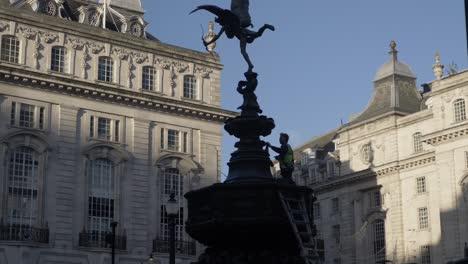 Silhouette-Of-Worker-Cleaning-Shaftesbury-Memorial-Fountain-In-London