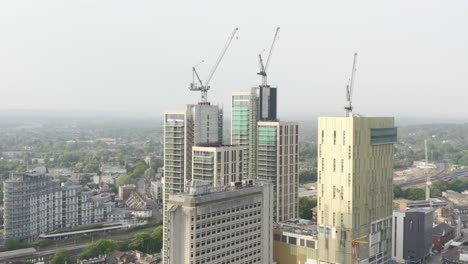 Drone-Aerial-shot-of-Woking-Cityscape-a-town-in-England-with-high-rise-skyscrapers-and-cranes-building-works-with-drone-circling