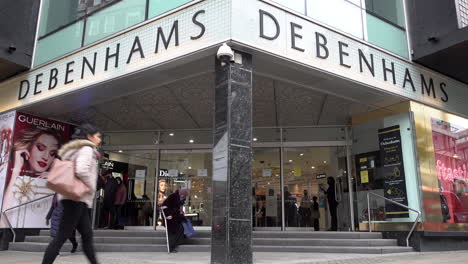 People-enter-and-leave-Debenhams-department-store-as-members-the-public-stroll-along-Oxford-Street-on-the-first-morning-Covid-restrictions-on-the-second-national-lockdown-are-relaxed