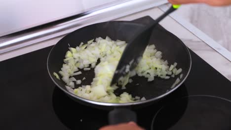 Stirring-onions-in-a-hot-pan