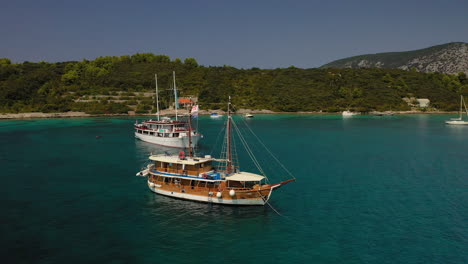 Travel-Talk-tour-boat-through-Adriatic-Sea,-Croatia,-aerial-view
