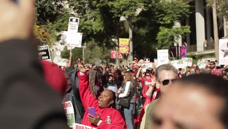 Woman-Celebrates-Success-at-Protest-Rally-in-a-Crowd-of-People,-Slow-Motion