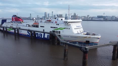 Stena-Line-freight-ship-vessel-loading-cargo-shipment-from-Wirral-terminal-Liverpool-aerial-left-dolly-view