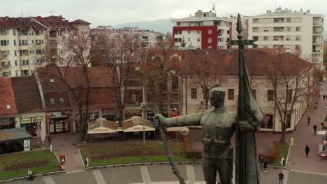 Serbian-warriors-square---Trg-Srpskih-ratnika---Monument-To-A-Serbian-Soldier-in-the-foreground,-Kraljevo