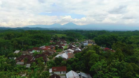 Aerial-view-of-residential-area-of-Temanggung,-Indonesia-village-by-rice-fields