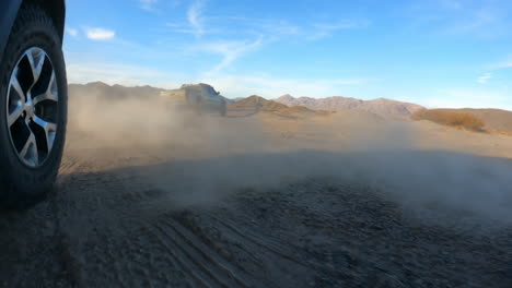 Slow-motion-of-wheels-spinning-up-and-kicking-up-dirt-on-an-off-road-trail