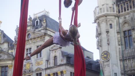 Athletic-,-gracious-woman-doing-a-beautiful-spin-during-an-acrobatic-performance-with-her-partner