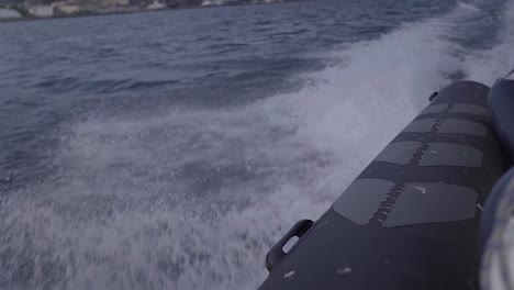 Speedboat-ride-on-the-ocean-with-crashing-waves-during-sunny-day