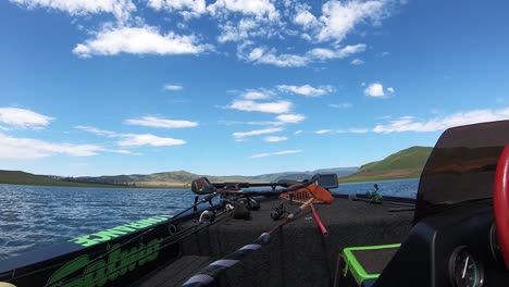 A-bass-boat-cruising-very-fast-on-a-calm-lake-on-a-beautiful-sunny-day