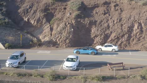 Aerial-view-of-royal-blue-BMW-i8-driving-on-road-in-Marin-Headlands,-Califonia