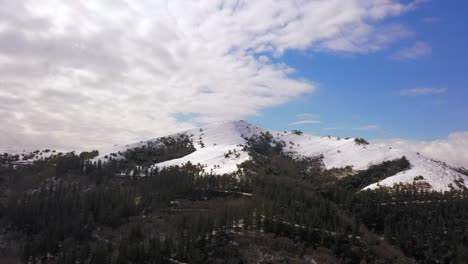 Scenic-landscape-of-Kolitza-Mount-summit-covered-in-Snow,-Aerial-towards-shot