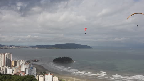 Afternoon-rain-clouds-roll-in-as-paragliders-float-above-Santos-Brazil
