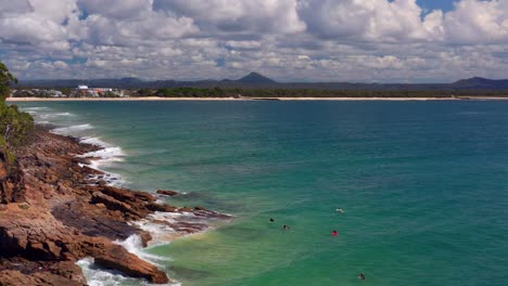 Flying-Over-Rocky-Shoreline-Of-Noosa-National-Park-With-Tourist-Near-Noosa-Heads,-QLD-Australia