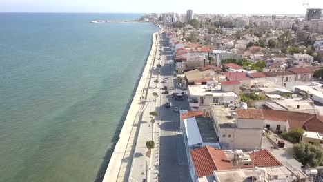 Drone-Flying-Low-Over-Old-Buildings-On-Mackenzie-Street-At-Beautiful-Seaside,-Larnaca-City,-Cyprus