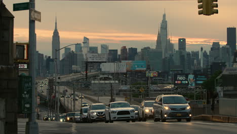 New-York-City-Skyline-With-Street-Traffic-And-Pedestrians-Passing-In-Foreground