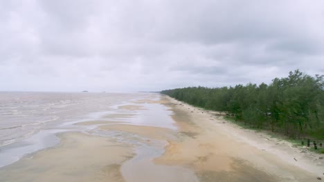 Aerial-flying-forward-over-deserted-beach-of-Rompin-on-cloudy-day,-Pahang,-Malaysia