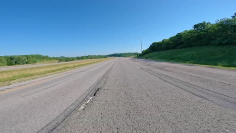POV-while-driving-on-The-Avenue-of-the-Saints-through-rural-Iowa-with-no-traffic-on-a-sunny-afternoon