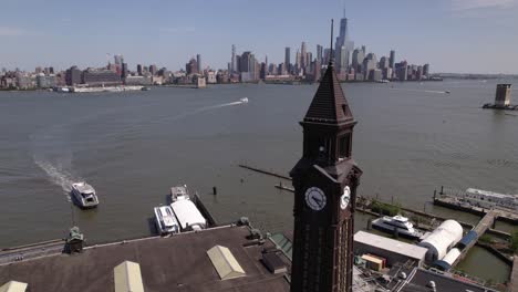 Aerial-view-of-a-ferry-arriving-to-the-Hoboken-Terminal,-in-New-Jersey,-USA---reverse,-drone-shot