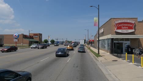 Traveling-in-the-Illinois-Chicago-land-area,-suburbs,-streets,-and-highways-in-POV-mode-people-coming-out-of-store