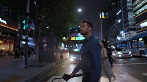 Man-walking-on-crosswalk-of-Gangnam-street-at-night-Seoul---slow-motion