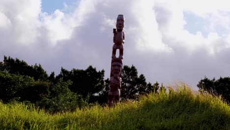 Maori-intricate-carved-statue-at-Oruaiti-Reserve-with-white-clouds-passing-in-the-capital-Wellington-New-Zealand-Aotearoa