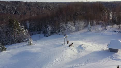 Drone-shot-panning-right-showing-how-people-get-off-from-ski-machine