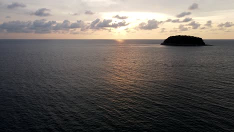 Antenne,-Die-Während-Des-Goldenen-Sonnenuntergangs-Mit-Der-Silhouette-Der-Insel-Im-Hintergrund-über-Ruhiges-Meer-Fliegt