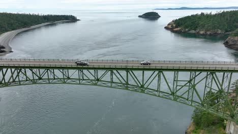 Drone-perspective-of-cars-driving-across-the-massive-bridge-at-Deception-Pass