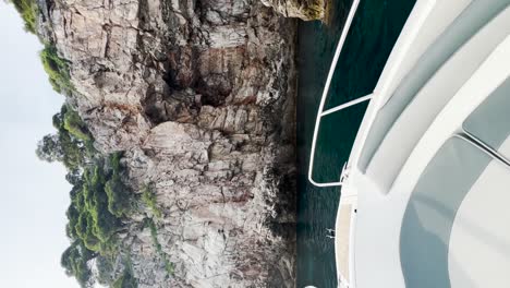 Entering-a-cave-on-the-sea-with-a-speedboat-in-Kolocep,-Croatia