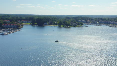 Drone-Aerial-Shot-of-a-Pontoon-Boat-Pulling-into-the-Marina-on-Lake-Norman