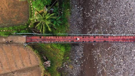 Top-Down-View-Of-People-On-The-Hanging-Footbridge-In-Guinsaugon,-Southern-Leyte-In-The-Philippines---aerial-drone-shot
