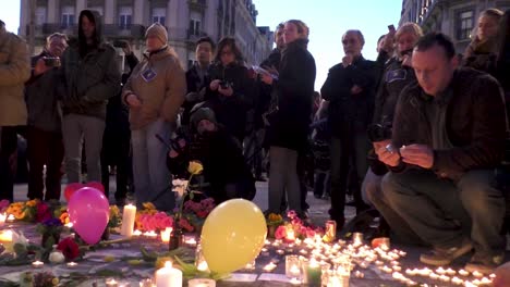 A-man-lights-a-candle-downtown-city-center-in-tribute-to-victims-of-terrorist-attack-on-Brussels-Airport-and-Metro-Maelbeek-earlier-that-day---Belgium