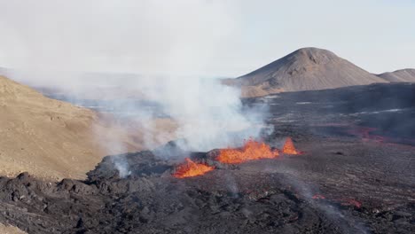Sunny-day-at-wild-violent-volcano-eruption-in-Meradalir-valley,-aerial