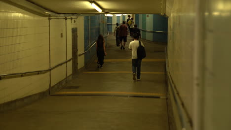 Hongkong--May-20,-2022:-motion-walking-citizens-through-the-hallway-of-the-subway
