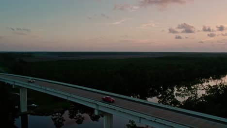 Aerial-panning-shot-of-Florida-Intracoastal-waterway-bridge-in-Northern-Florida-at-sunset