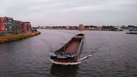 Beautiful-Shot-Of-Candesso-Cargo-Ship-Changing-Direction-Towards-Port-Shore,-Netherlands