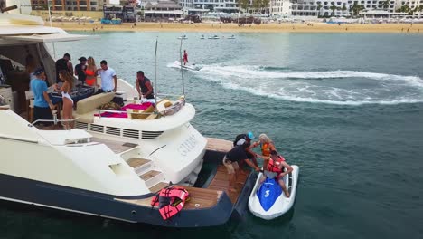 A-group-of-friends-enjoying-a-holiday-with-outdoor-sports-and-travels-and-partying-on-a-luxury-Yacht-in-the-middle-of-the-sea