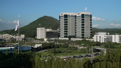Seoul-Cuty-Skyline-Mit-Blick-Auf-Die-Hauptgebäude-Der-Hyundai-Motor-Group-Gegen-Berge-Und-Autos,-Die-Auf-Der-Gyeongbu-schnellstraße-In-Seocho-gu,-Seoul,-Fahren